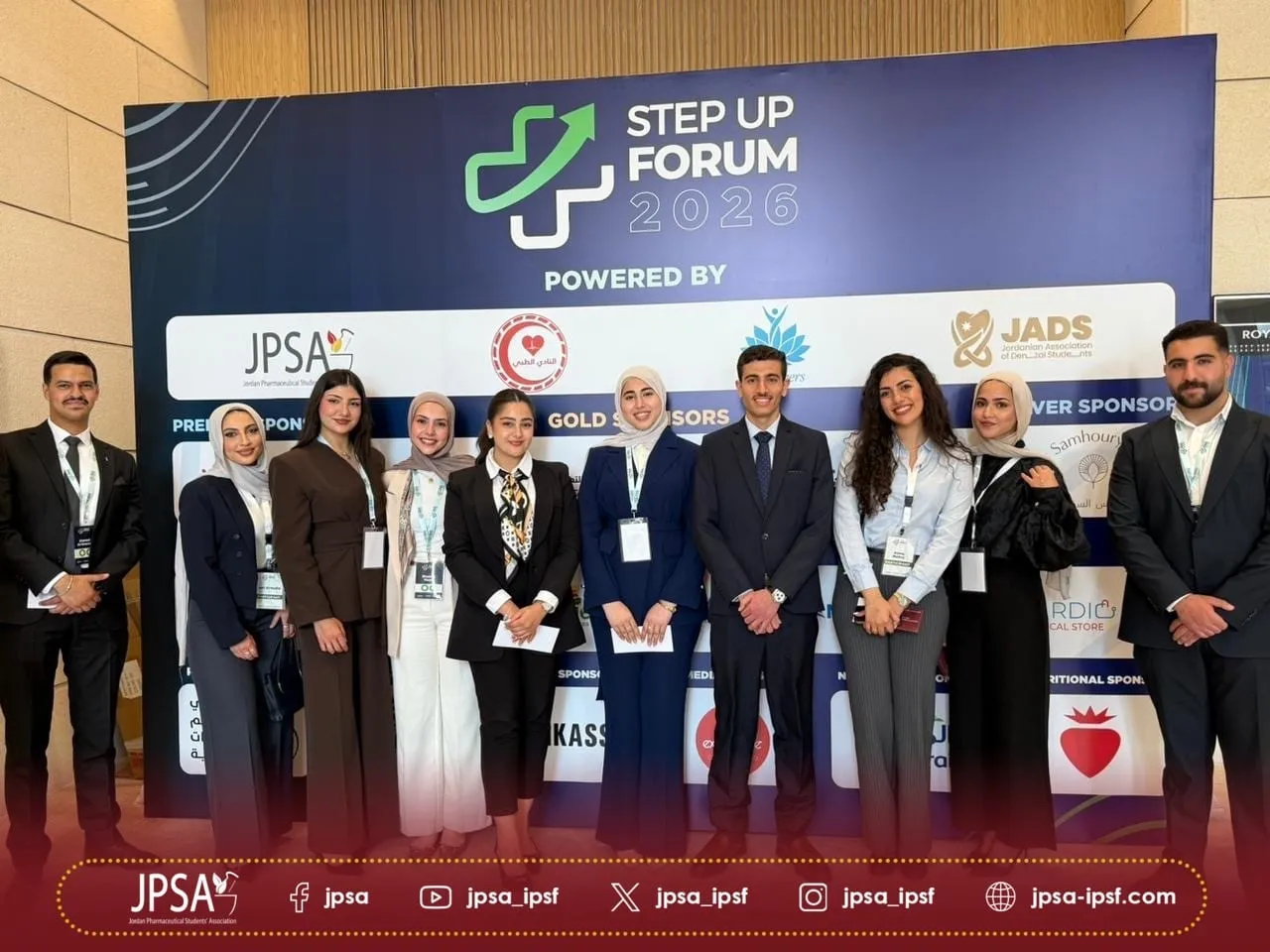 A group posing in front of the Step Up Forum 2026 sponsor wall