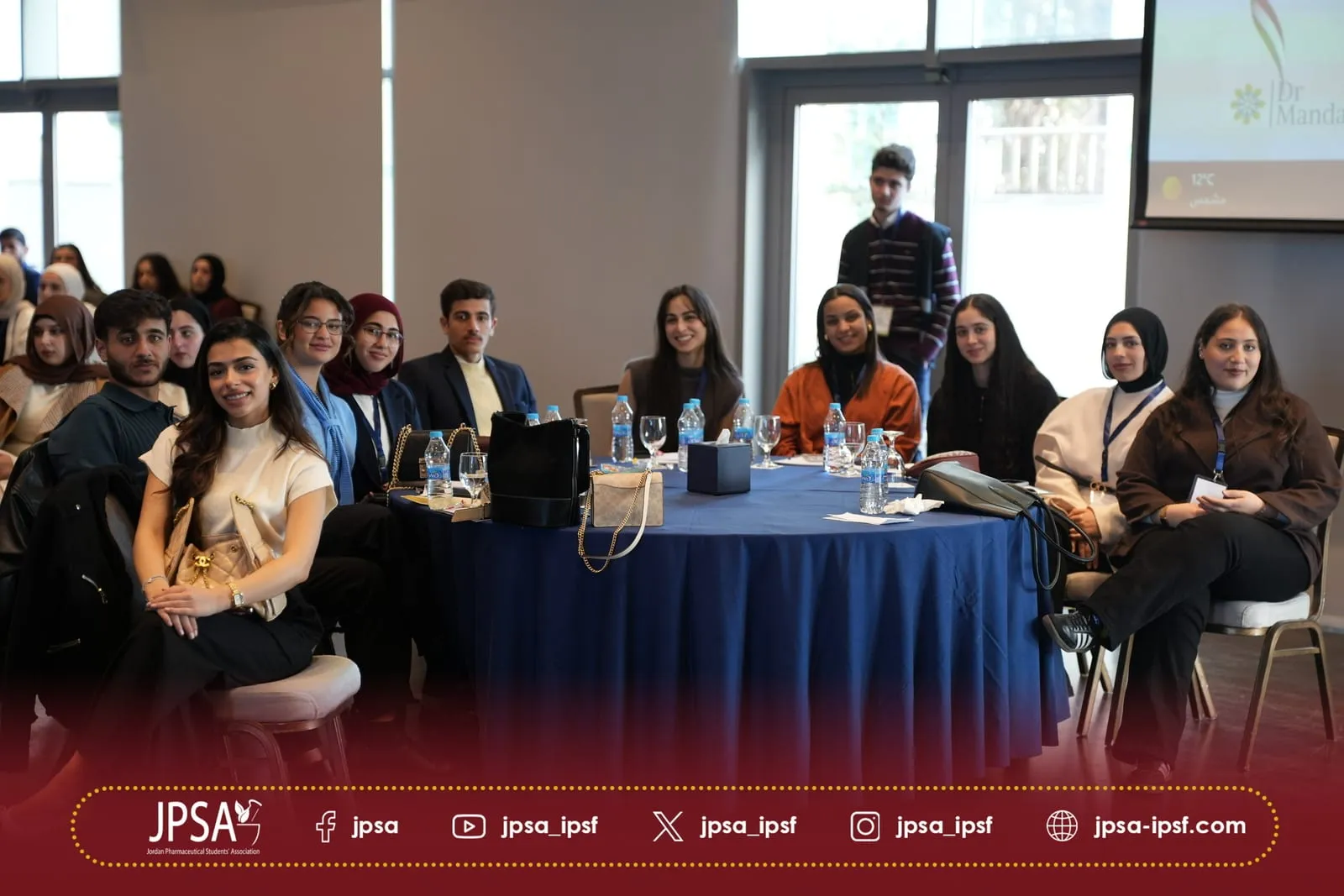 Attendees seated around a round table during a session