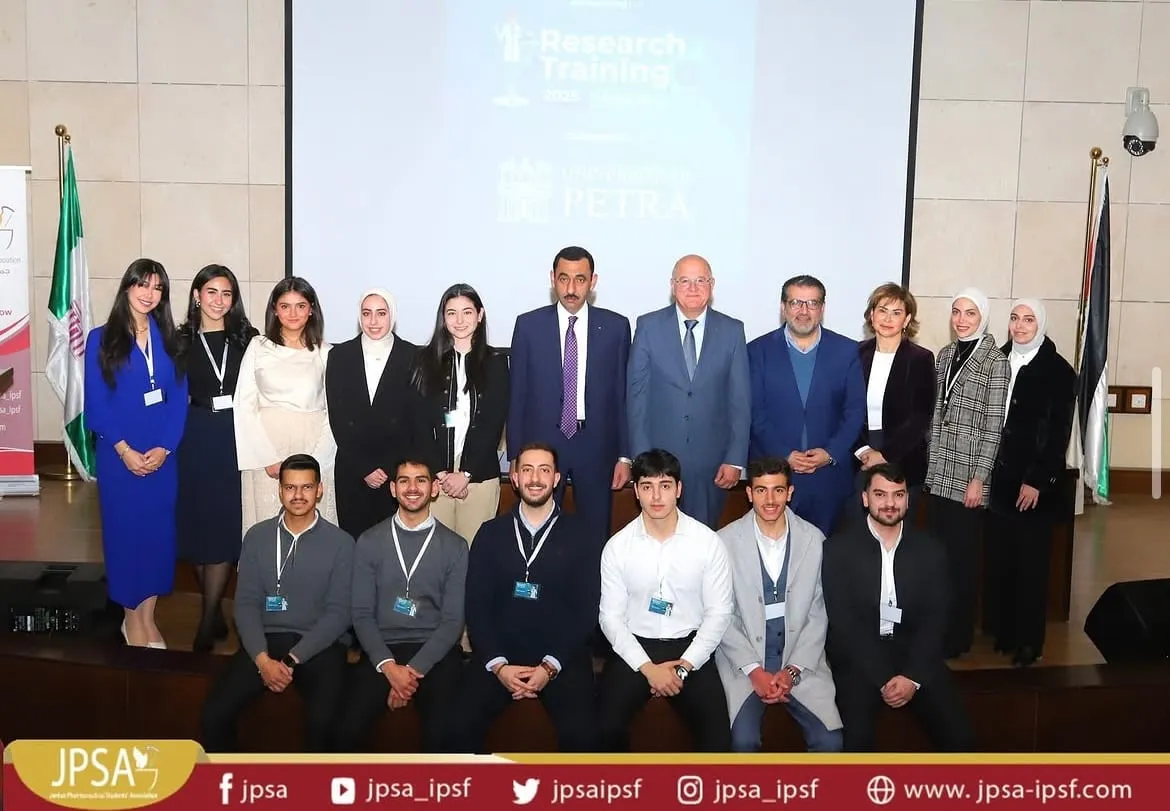 A large group photo on a lecture hall stage