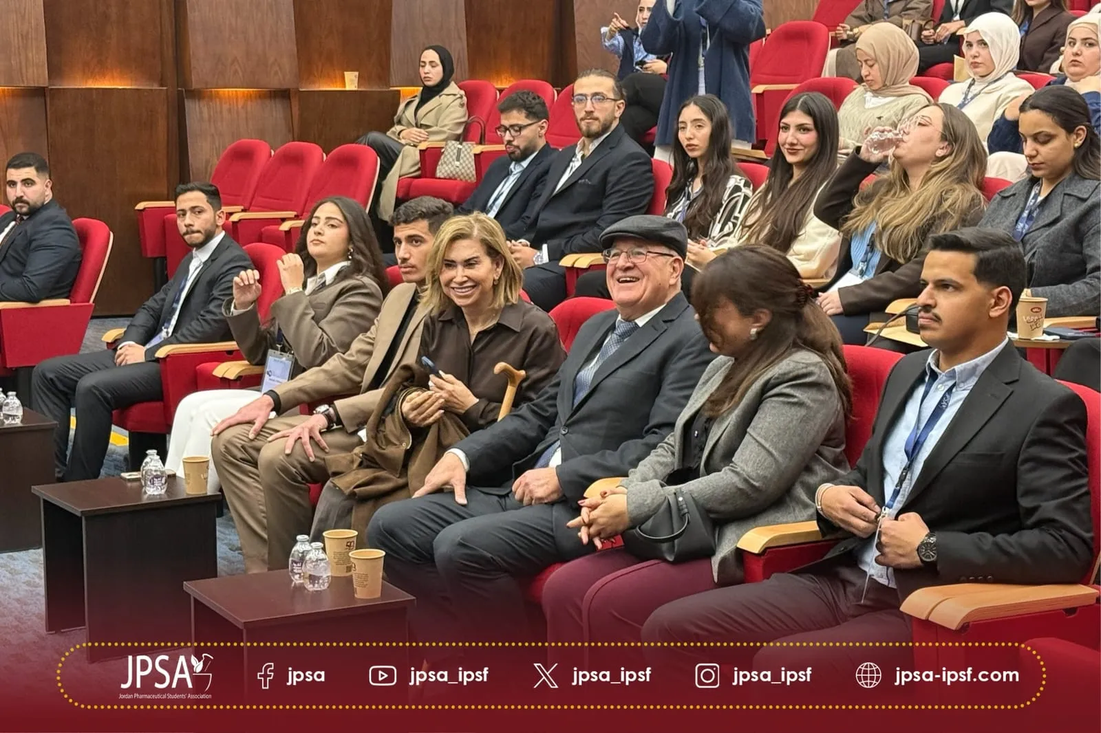 The audience smiling in the front rows of a lecture hall
